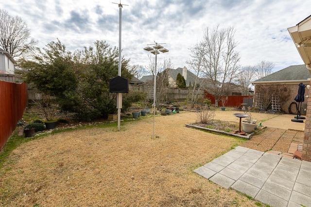 view of yard featuring a fenced backyard and a patio