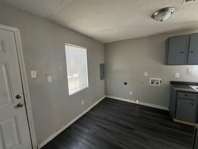 washroom with dark wood-style floors, washer hookup, cabinet space, electric dryer hookup, and baseboards