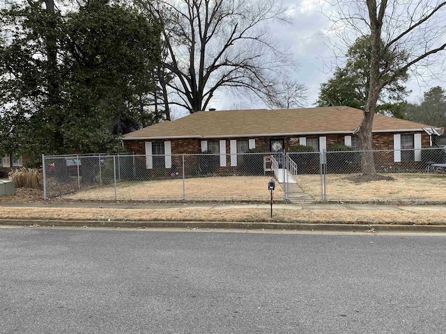 view of front facade featuring a fenced front yard and a carport