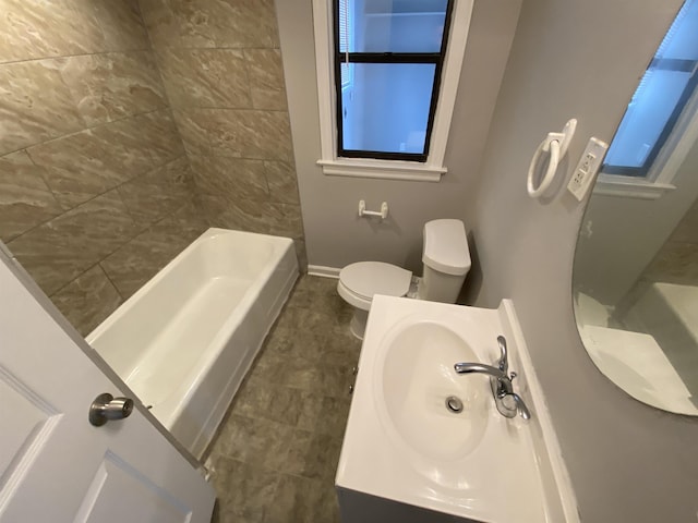 bathroom with vanity, toilet, and baseboards