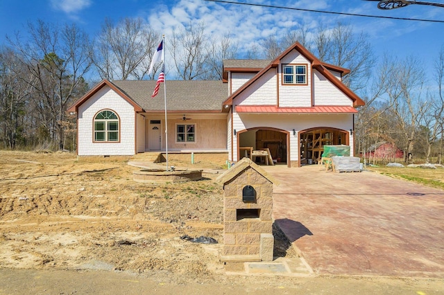 view of front facade featuring a garage, a shingled roof, concrete driveway, crawl space, and a standing seam roof