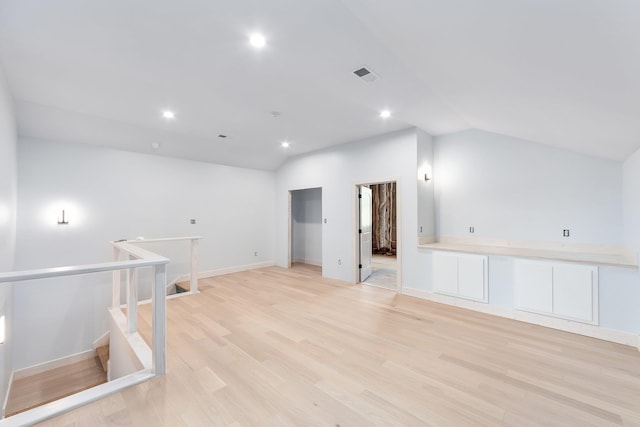 bonus room featuring light wood-type flooring, lofted ceiling, visible vents, and recessed lighting