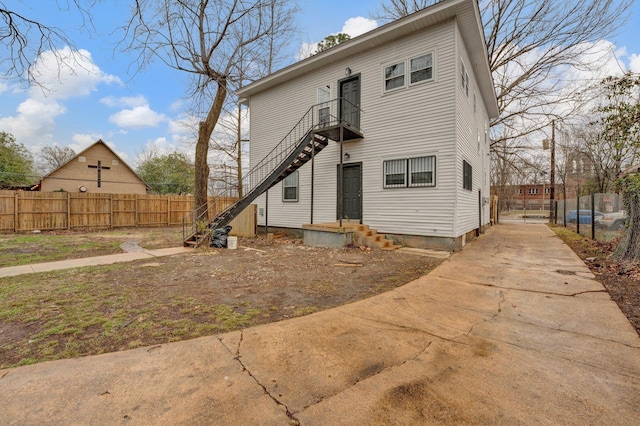 rear view of property with fence