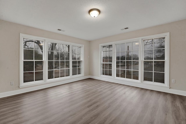 unfurnished sunroom featuring visible vents