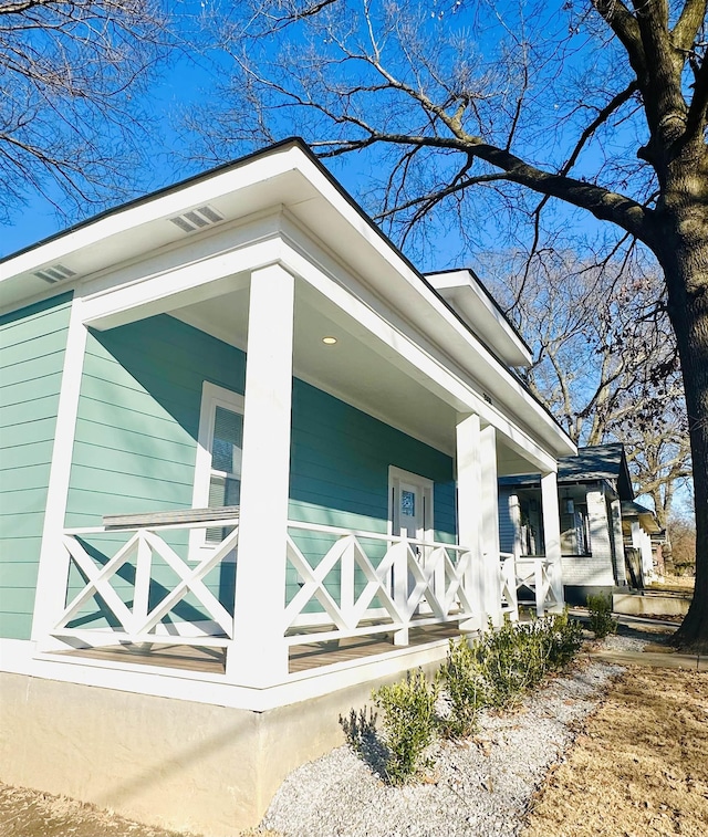 view of side of home with a porch