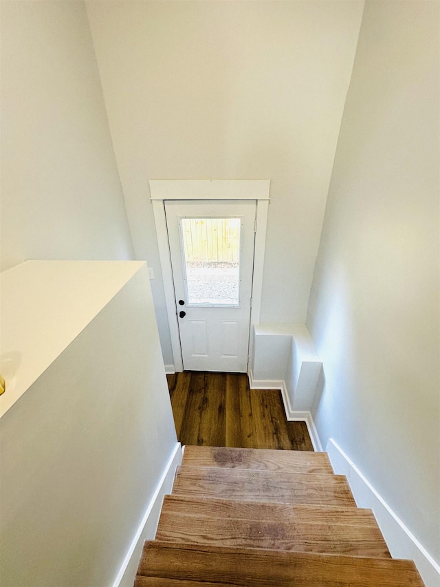 stairway with baseboards and wood finished floors