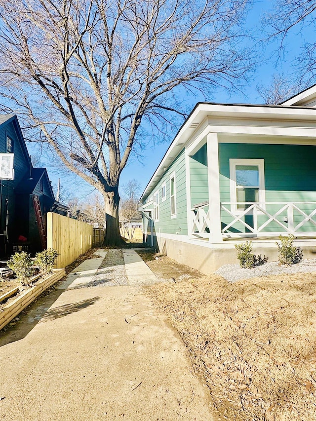 view of side of home with fence