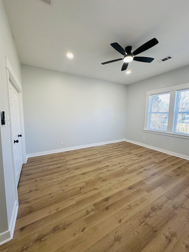 spare room with recessed lighting, visible vents, ceiling fan, wood finished floors, and baseboards