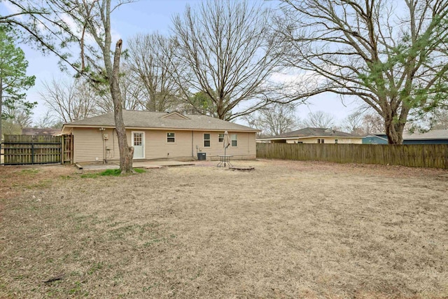 back of house featuring central AC, a patio area, and a fenced backyard