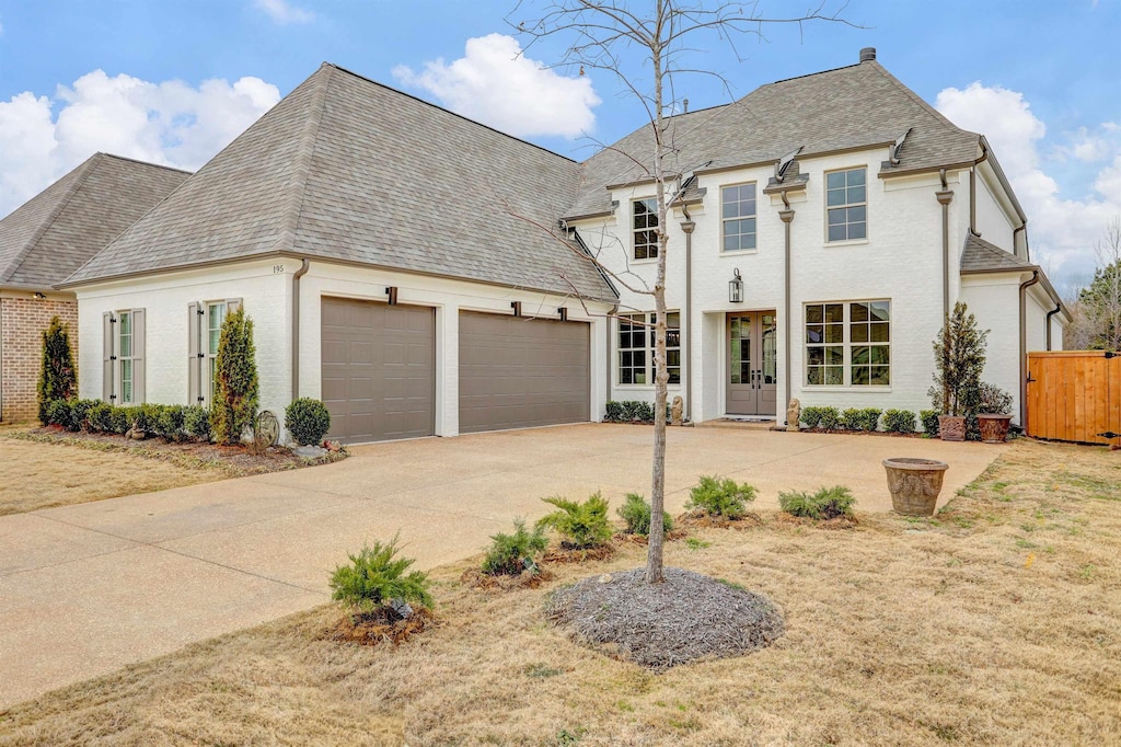 195 Pierpont Ct, Piperton, TN 38017 - french provincial home with roof with shingles, driveway, and an attached garage