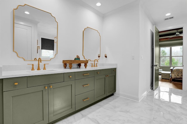 ensuite bathroom featuring marble finish floor, ornamental molding, a sink, and visible vents