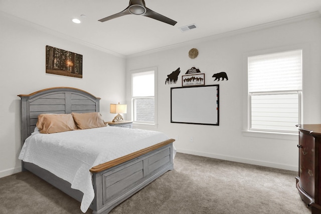 carpeted bedroom with recessed lighting, a ceiling fan, baseboards, visible vents, and crown molding