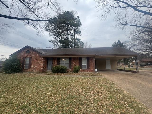 ranch-style home with driveway, a front lawn, a carport, and brick siding