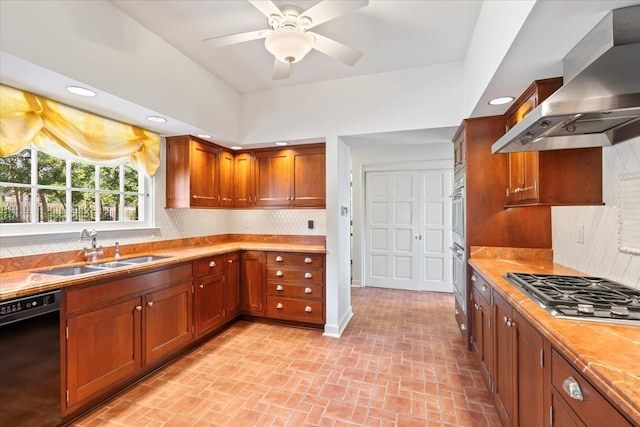 kitchen with stainless steel appliances, backsplash, a sink, and wall chimney range hood