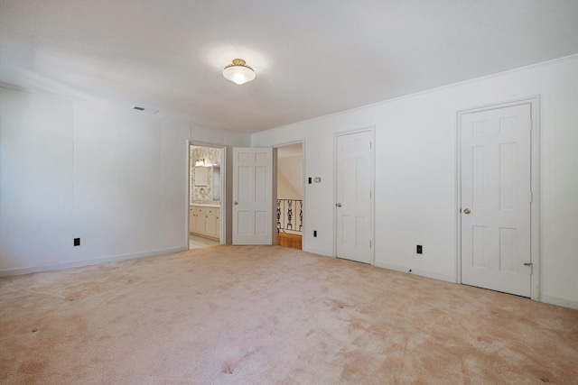 unfurnished room featuring baseboards, visible vents, and carpet flooring