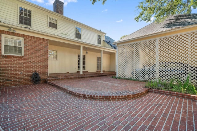 back of house featuring a patio area and a chimney