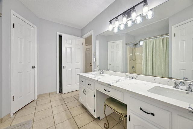 bathroom with double vanity, a shower with curtain, tile patterned flooring, and a sink