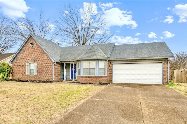 view of front of home with brick siding, roof with shingles, an attached garage, driveway, and a front lawn