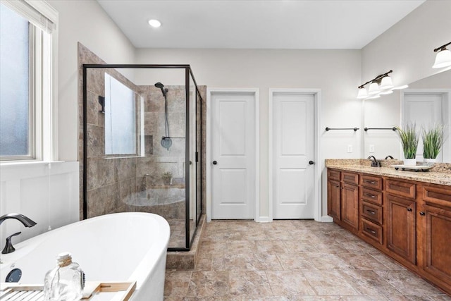 bathroom with a freestanding bath, double vanity, and a shower stall