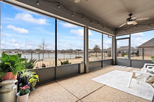 sunroom featuring a ceiling fan and track lighting