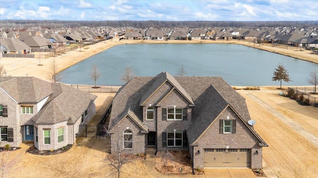 birds eye view of property featuring a water view and a residential view