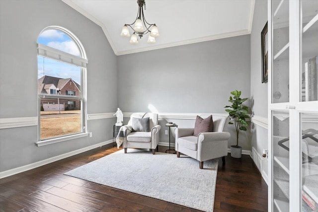 sitting room with baseboards, dark wood finished floors, ornamental molding, vaulted ceiling, and a chandelier