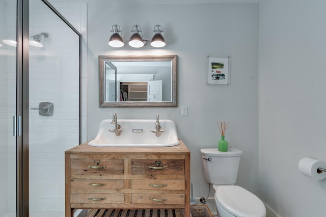 bathroom with a stall shower, vanity, and toilet