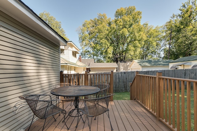 wooden terrace featuring fence private yard and outdoor dining space