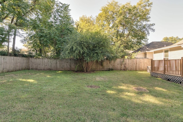 view of yard with a fenced backyard and a wooden deck