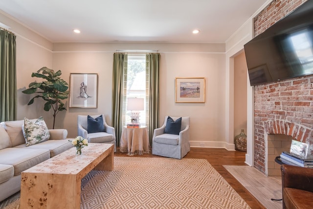 living room with a fireplace, baseboards, wood finished floors, and recessed lighting