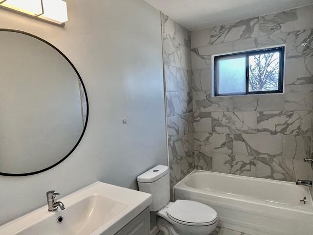 full bathroom featuring toilet,  shower combination, and vanity