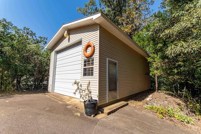 view of home's exterior featuring an outbuilding and a detached garage