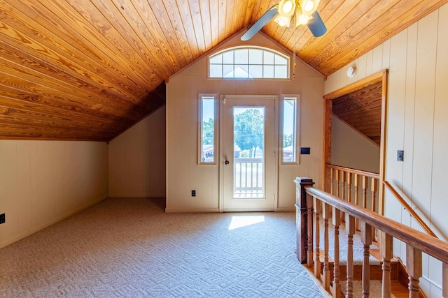 carpeted foyer entrance with a ceiling fan, wooden ceiling, and vaulted ceiling with beams