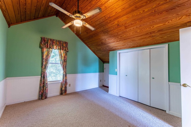 unfurnished bedroom featuring carpet floors, wood ceiling, and wainscoting