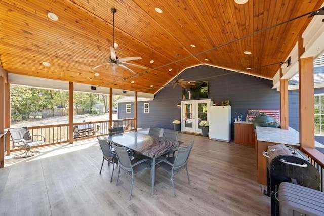 dining space featuring ceiling fan, wood finished floors, wood ceiling, vaulted ceiling, and french doors