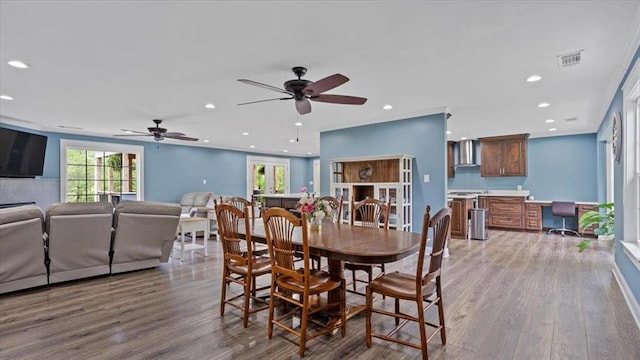 dining space with recessed lighting, visible vents, wood finished floors, and built in study area