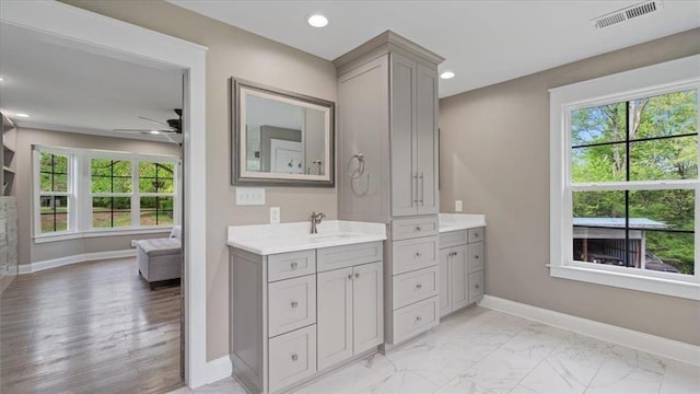 bathroom with visible vents, baseboards, marble finish floor, vanity, and recessed lighting