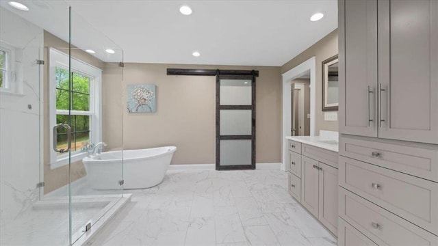 bathroom featuring marble finish floor, recessed lighting, a freestanding bath, a shower stall, and baseboards