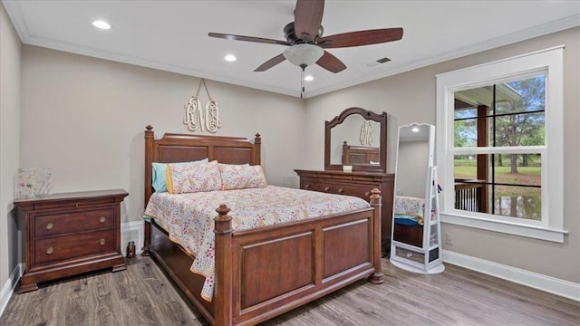 bedroom with ornamental molding, light wood-style flooring, visible vents, and baseboards