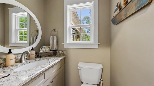 bathroom with toilet and vanity