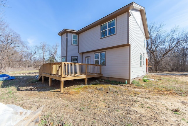 back of property featuring crawl space and a wooden deck