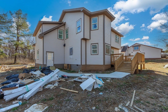 back of house featuring a deck