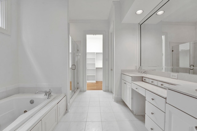 bathroom featuring a spacious closet, a stall shower, vanity, a whirlpool tub, and tile patterned floors