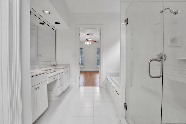 bathroom featuring a stall shower, tile patterned flooring, vanity, and a bath