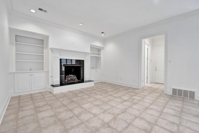 unfurnished living room featuring baseboards, visible vents, built in features, ornamental molding, and a fireplace