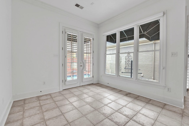 spare room with baseboards, visible vents, crown molding, and french doors