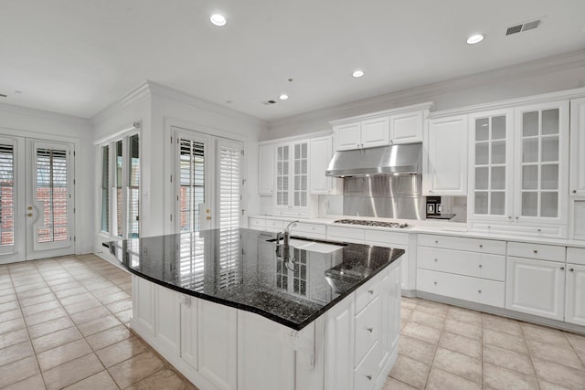 kitchen featuring ornamental molding, french doors, stainless steel gas stovetop, and under cabinet range hood