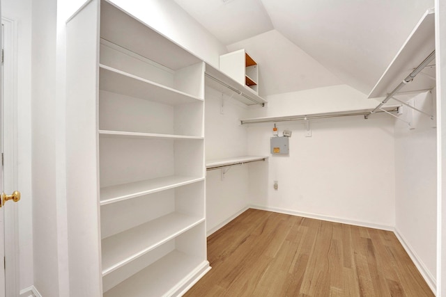 spacious closet featuring lofted ceiling and light wood finished floors