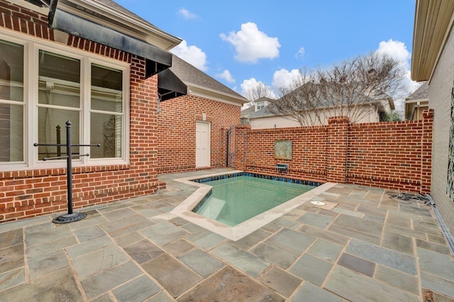 view of pool featuring a patio area, fence, and a fenced in pool