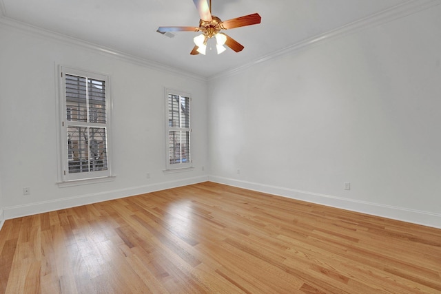 spare room with ceiling fan, ornamental molding, light wood-style flooring, and baseboards